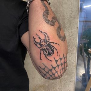 Unique illustrative tattoo featuring a majestic stag and intricate beetle design by Charlie Macarthur.