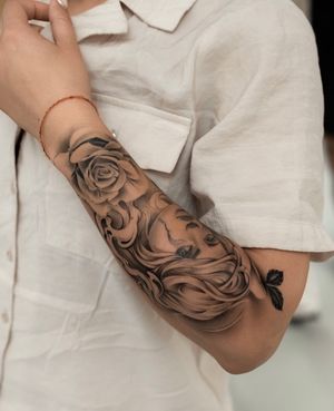 Stunning black and gray tattoo by Ion Caraman featuring a realistic chicano style rose and woman design.