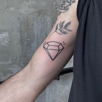 Bold illustrative diamond tattoo by renowned artist Charlie Macarthur, showcasing unique style and precision.