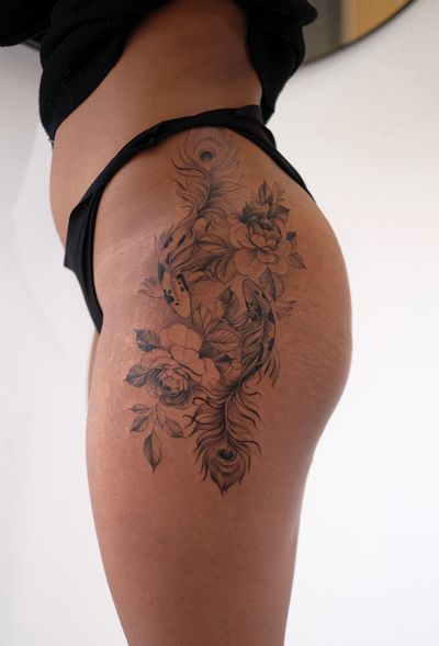 Experience the beauty of a koi fish swimming among delicate flowers on your hip, created by Ion Caraman.