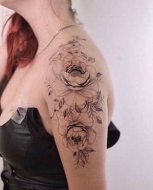 Express your love for flowers with this stunning floral tattoo on your shoulder, created by the talented artist Ion Caraman.