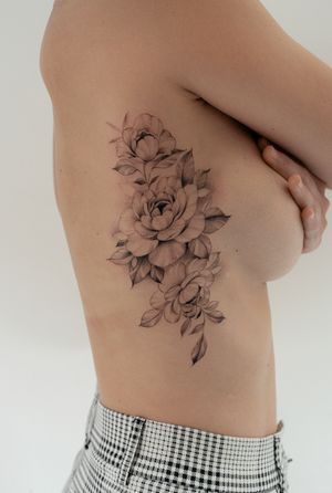 Adorn your ribs with a delicate flower motif in this stunning floral tattoo designed by the talented artist Ion Caraman.