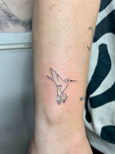 Unique hand-poked illustrative tattoo of a beautiful hummingbird by Charlotte Pokes. A symbol of grace and freedom.