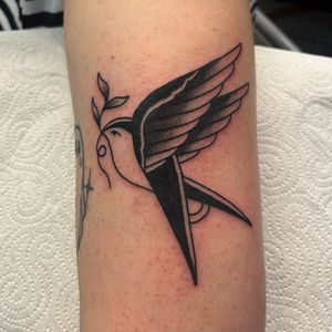 Get a classic traditional swallow tattoo design by the talented artist Claudia Vicente. Perfect for a timeless and iconic look.