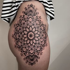 Experience Karen Buckley's intricate dotwork and geometric style in this stunning mandala tattoo design.