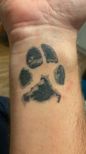 Hand-poked pet paw tattoo by Charlotte Pokes, capturing the essence of your furry friend.
