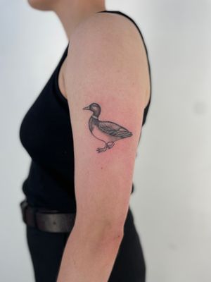 Admire Paula's intricate dotwork prowess in this charming duck motif tattoo.