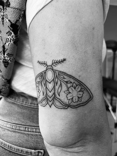 Unique dotwork style tattoo featuring a intricate moth and flower design by Claudia Vicente.