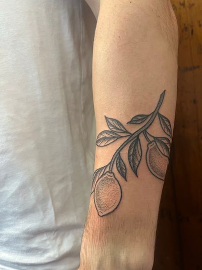 Experience unique dotwork and illustrative style by Claudia Vicente in this stunning lemon branch tattoo design.
