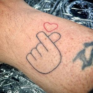 Get a delicate hand-poked heart tattoo by Charlotte Pokes for a unique and minimalist design.