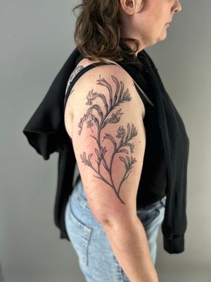 Get a stunning black and gray illustrative flower tattoo by the talented artist Paula. Embrace the beauty of nature with this intricate botanical design.