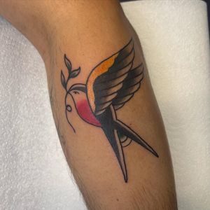 Get a classic traditional tattoo of a swallow by the talented artist Claudia Vicente. Perfect for those looking for a timeless design.