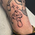 Explore the whimsical world of mushrooms with this vibrant traditional tattoo by Claudia Vicente. Perfect for nature lovers!