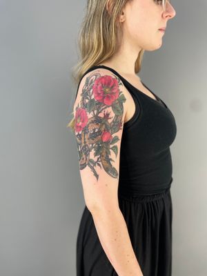 An illustrative tattoo featuring a snake and rose design by the talented artist Paula. Perfect for those who appreciate neo-traditional style artwork.