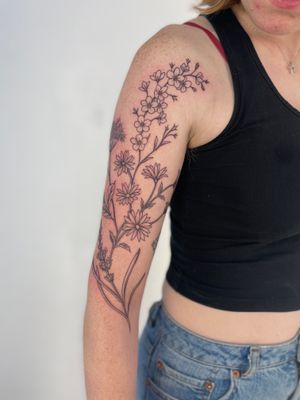 Adorn your skin with Paula's beautiful floral and illustrative tattoo featuring intricate botanical motifs.