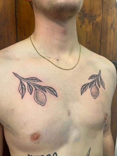 Get a unique twist on a classic fruit with this dotwork lemon branch tattoo by the talented artist Claudia Vicente.