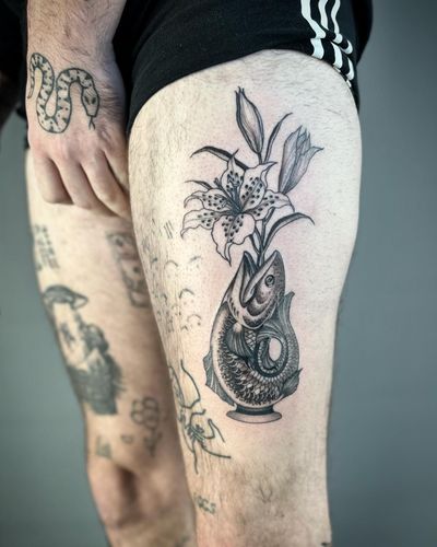 Get a stunning illustrative tattoo featuring a fish, flower, lily, and botanical elements, created by Paula.