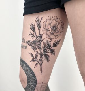 Get a stunning illustrative tattoo featuring a butterfly, flower, and rose by the talented artist, Paula. Embrace the beauty of nature in body art.