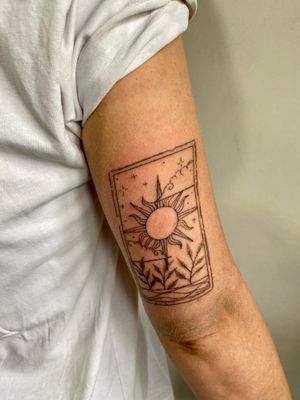 Discover the magic in dotwork and fine line with this hand-poked sun tarot card tattoo by Charlotte Pokes.