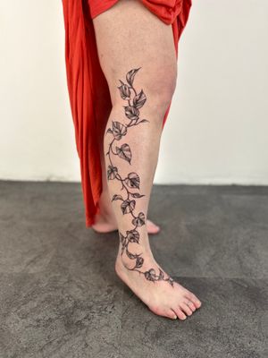Bring nature's beauty to your body with this elegant illustrative tattoo featuring intricately detailed vines and leaves. Created by the talented artist Paula.
