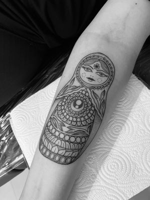 Explore the intricate world of Russian nesting dolls with this stunning geometric and illustrative tattoo design by the talented artist Claudia Vicente.
