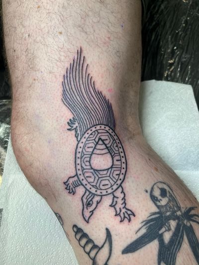 Get a unique illustrative and traditional tattoo featuring a beautiful Aztec turtle design by talented artist Claudia Vicente.