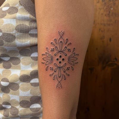 Experience the beauty and intricacy of fine line work with this delicate lotus tattoo design. Created by the talented artist Claudia Vicente.