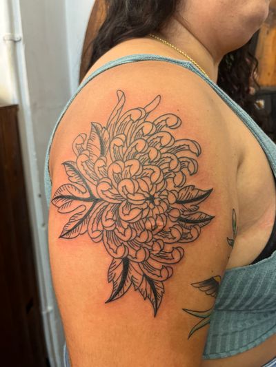 Beautiful floral tattoo by Claudia Vicente featuring a detailed chrysanthemum design.