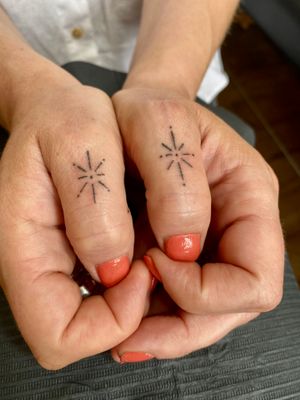 Get inked with Charlotte Pokes' ignorant style tattoo featuring a star and sparkels - a unique design for your finger.
