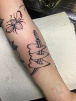 Get inked with a striking traditional tattoo featuring a heart intertwined with a sword, expertly crafted by Claudia Vicente.