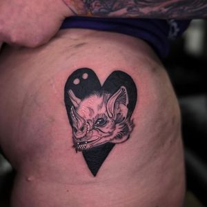 Express your love for the darkness with this stunning illustrative tattoo of a bat and heart by the talented artist, Holly Valley.