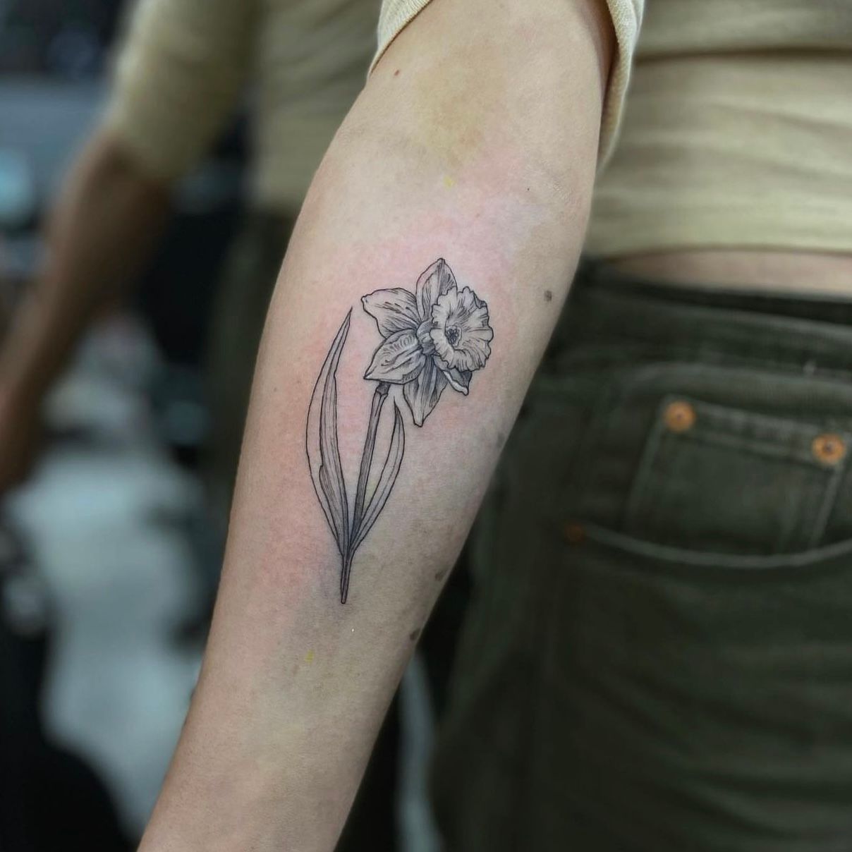 Fine line daffodil and bluebells tattoo on the inner