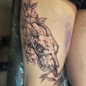 Beautifully detailed illustrative tattoo by Holly Valley combining a flower and skull motif in a neo-traditional style.