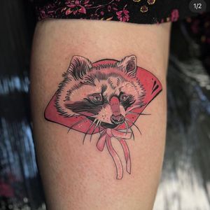 Get a unique neo-traditional tattoo featuring a raccoon, fan, and ribbon by the talented artist Holly Valley.