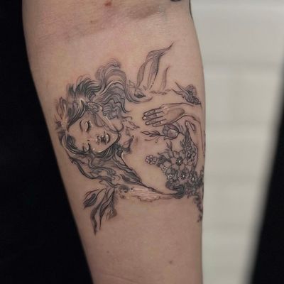 Experience the magic of nature with this fine-line illustrative tattoo by Holly Valley. Featuring a delicate fairy surrounded by beautiful flowers.