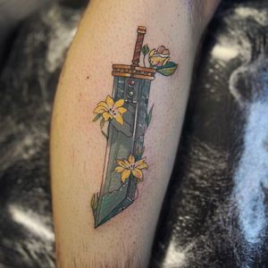 Get inked with a stunning tattoo by Holly Valley featuring a delicate lily flower intertwined with the iconic Buster Sword from Final Fantasy VII. A perfect blend of anime and illustrative styles.