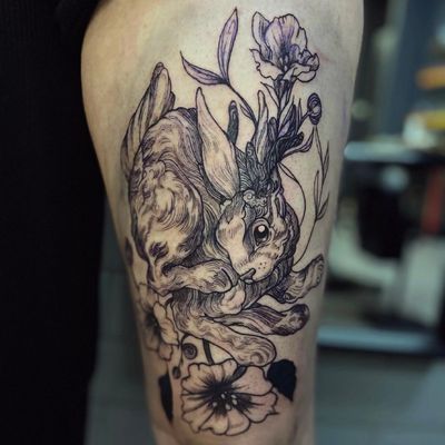 Unique woodcut style tattoo by Holly Valley featuring a rabbit and flower motif in intricate etching detail.