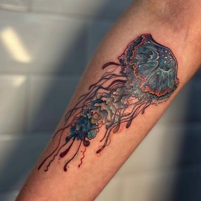 Get mesmerized by this illustrative galaxy jellyfish tattoo by artist Holly Valley. A vibrant masterpiece of cosmic beauty.