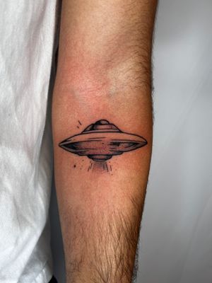 Experience out-of-this-world vibes with this dotwork UFO tattoo by Jonathan Glick. Intricately detailed and boldly unique.