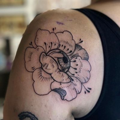 Experience the beauty of Japanese art with this illustrative tattoo featuring a chrysanthemum flower and captivating eye by artist Holly Valley.