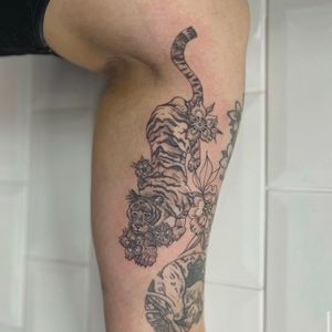 Get a stunning illustrative tattoo of a tiger and flower by the talented artist Holly Valley.