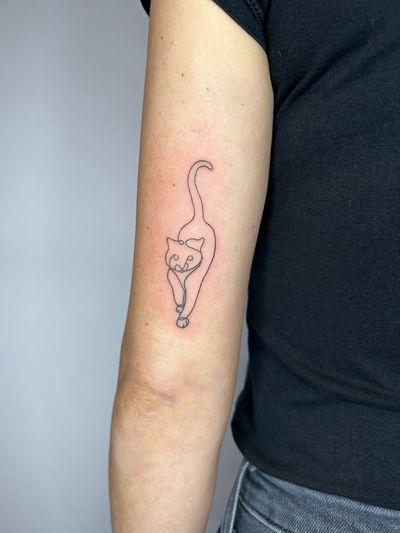 Embrace the elegance of this fine line, single line cat tattoo by acclaimed artist Jonathan Glick. Perfect blend of simplicity and artistry.