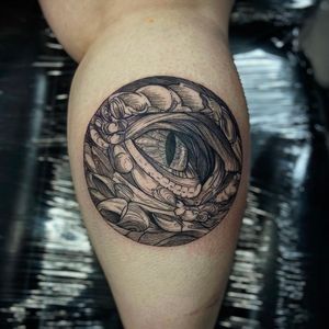 Capture the mystique of the medieval era with this illustrative dragon tattoo by Holly Valley featuring intricate etching details and a piercing eye.