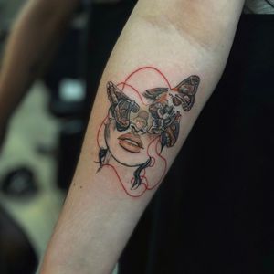 Experience the delicate beauty of a fine line neotraditional tattoo featuring a mysterious moth and a lady connected by a striking red thread. By Holly Valley.