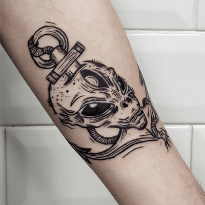 Unique and eye-catching tattoo design featuring a combination of an anchor and alien motif, created by talented artist Adam McDade.