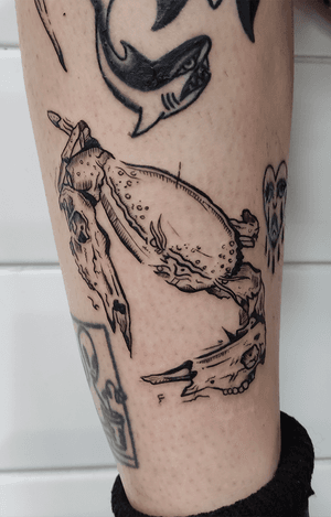 Capture the beauty of the sea with this intricate illustrative crab tattoo, expertly designed by artist Adam McDade.