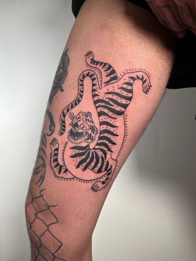 Get inked with a fierce and timeless tiger design by the talented artist Dave Norman. Perfect for those who appreciate traditional tattoo styles.