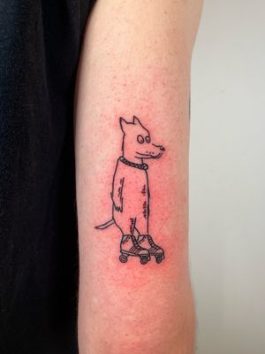 Get inked with this cool illustrative and ignorant tattoo of a dog wearing roller skates by artist Dave Norman.