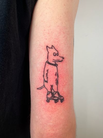 Get inked with this cool illustrative and ignorant tattoo of a dog wearing roller skates by artist Dave Norman.