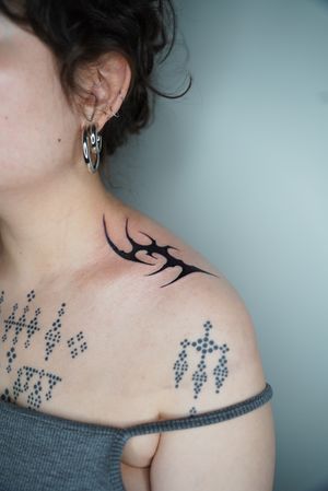 Illustrative tribal tattoo featuring cyber sigil motif by Dominga Longo, a fusion of ancient tribal symbols and modern cyber aesthetics.